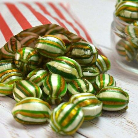 Green, gold and white striped Parkhead (Celtic FC) balls spilling from a red and white striped paper bag.