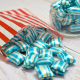 Blue & white striped colour flavour boiled sweets in a paper bag.