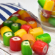Fruit Rock, colourful, fruit flavoured hard boiled rock pieces spilling from a paper bag